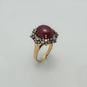 A Ring with Cabochon Ruby and zircons